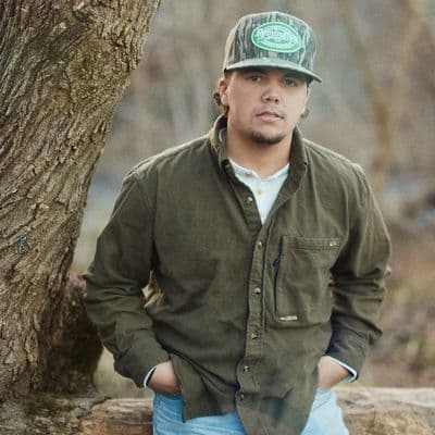 John Cooper Albright looking at camera in the woods